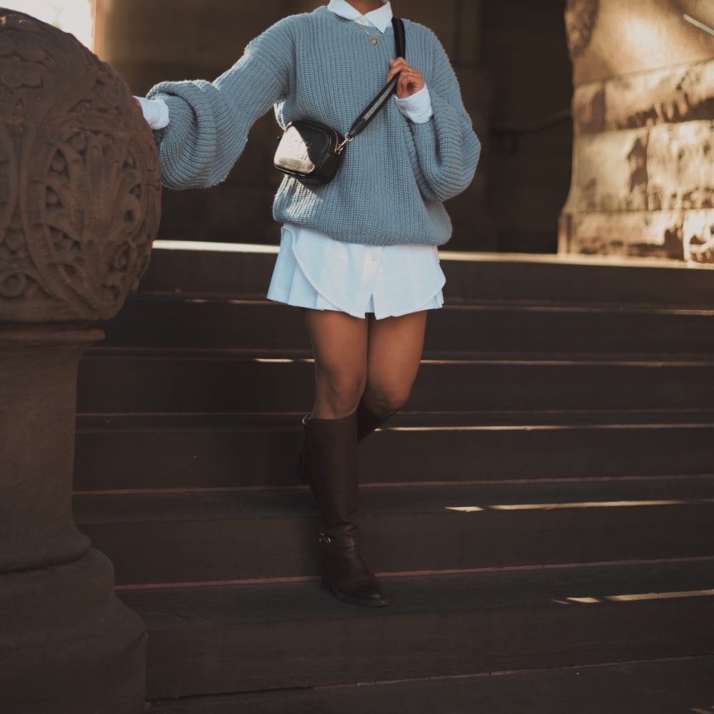 Baby blue sweater with bell shaped sleeves.